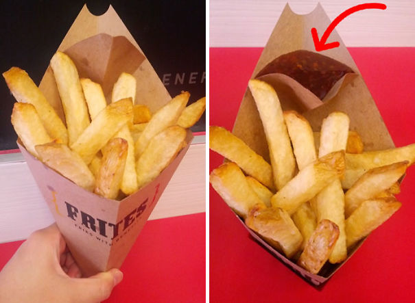 Una confezione di patate fritte take away con lo spazio per la salsa.