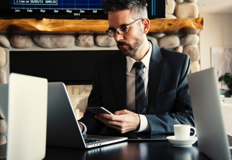 Man in black holding phone